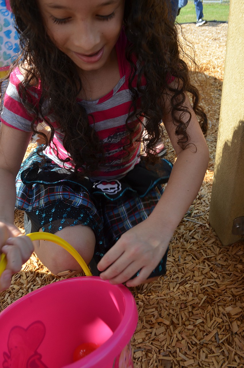 Emily Hernandez searches for eggs.