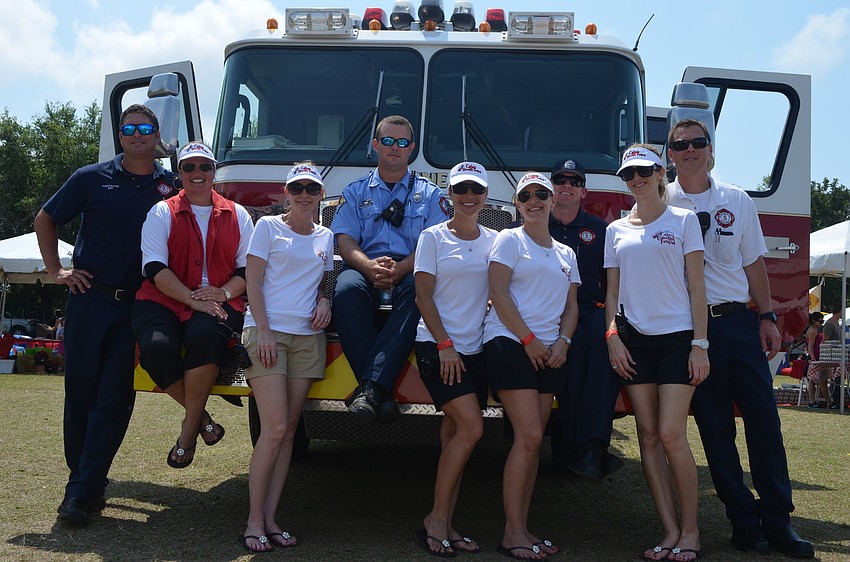Firefighters Mike Smith, Kyle Carrigan, Grant Abrams and Travis Dagenais with Cajun Crawfish Festival co â€“ chairs