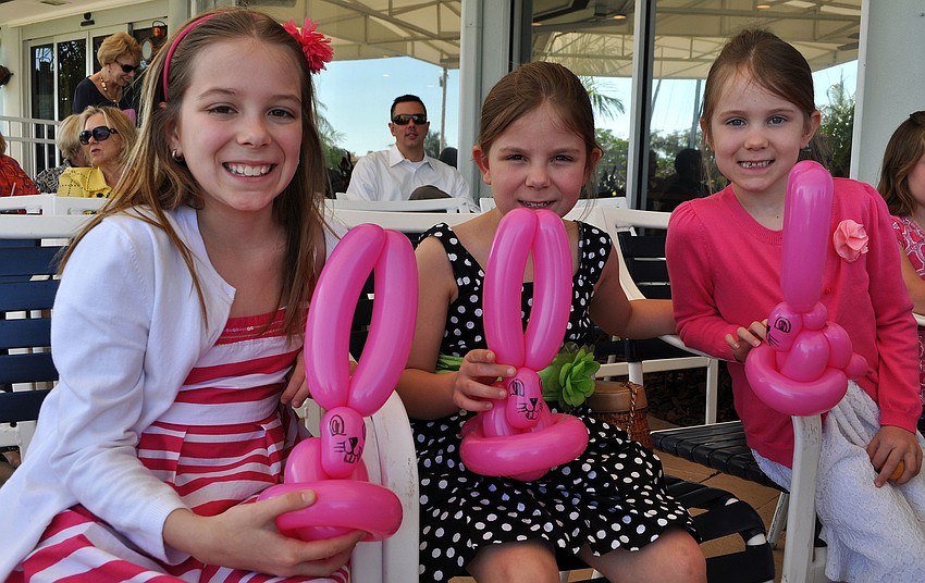 Jade Gallagher, 10, with her sisters Emma, 8, and Brooke, 5, and their pink bunny balloons.