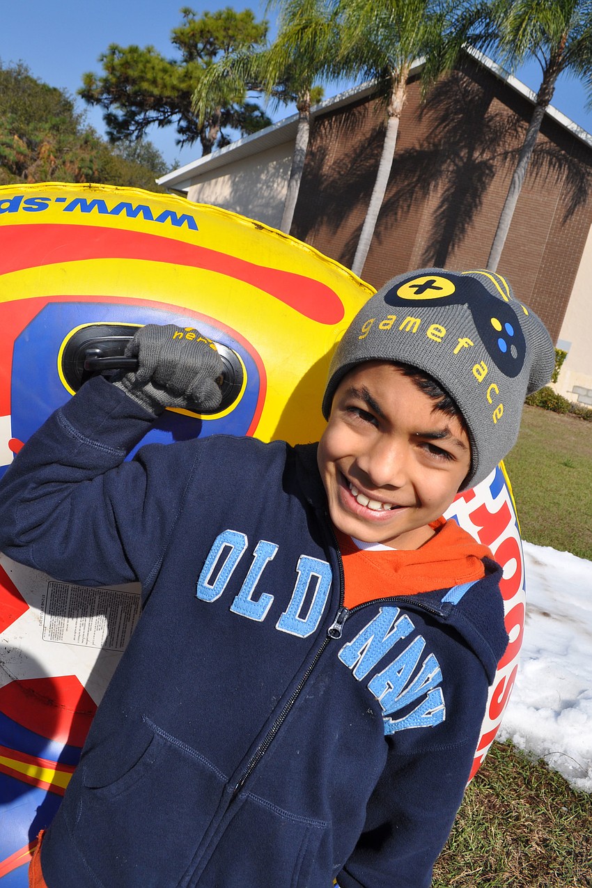 Sebastian Morelli, 9, carried his tube sled back to the top of the hill.