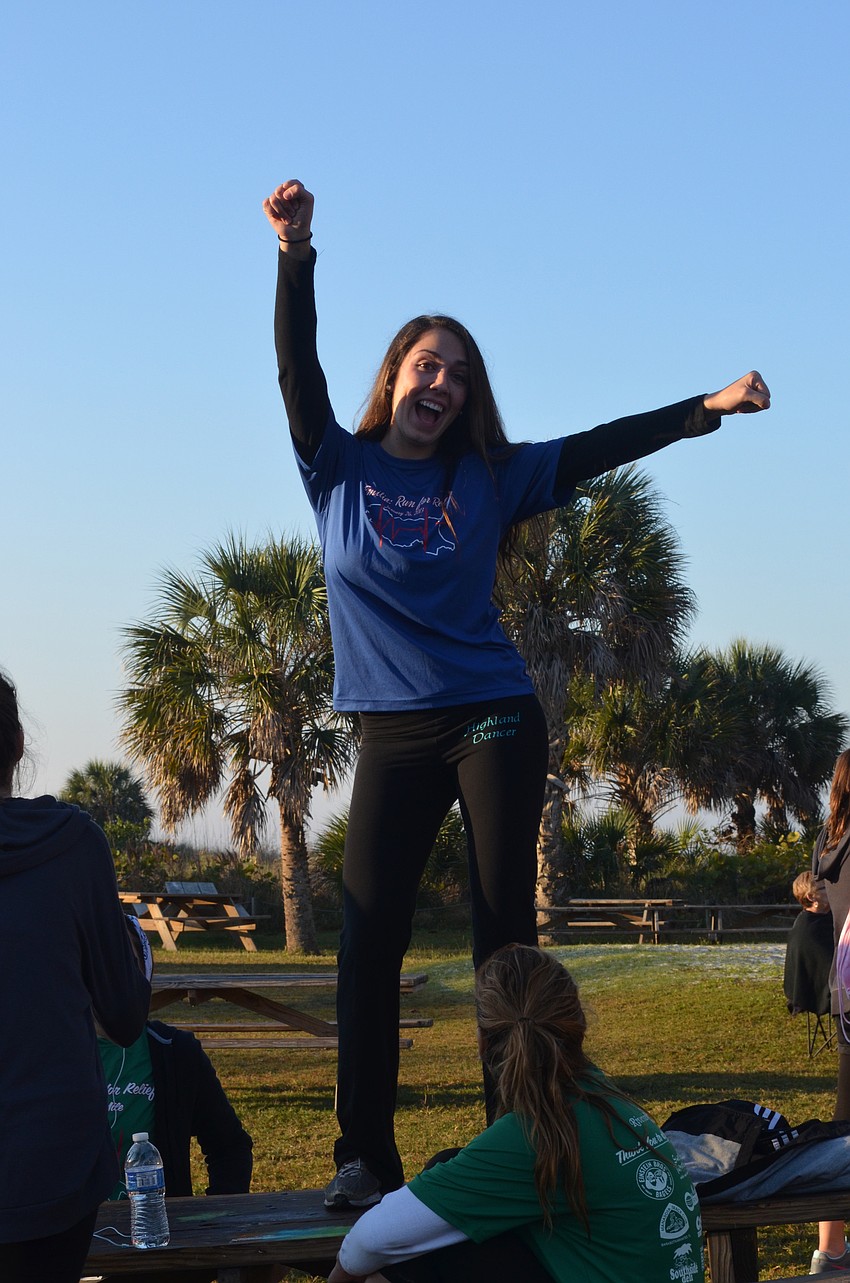 Jaclyn Falconetti cheers on the runners.