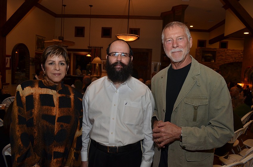 Jill Hoffman Kowal stands with Rabbi Chaim Steinmetz and her husband Dennis.