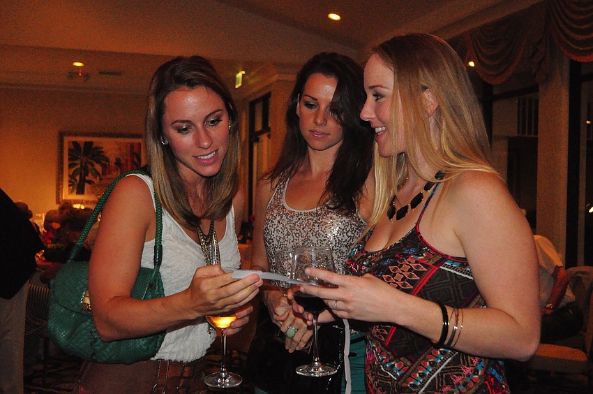 Jennie Baumberger, Gabrielle Otero and Catherine Swiftverly check their raffle tickets.