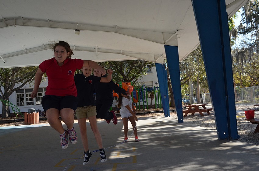 Caroline Bailey, Sophia Joerger and Brooke Beebe jump the same rope.