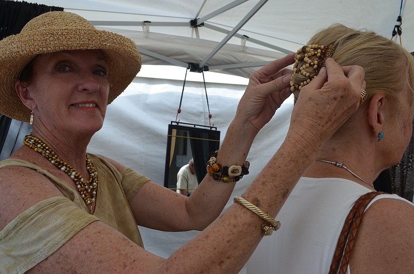 Patti VanTonder adjusts kudu clip in Jeanette Battlesâ€™s head.