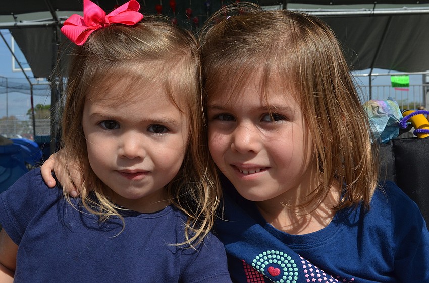 Julianne Coyne, 2, visits the festival with her older sister Carolina, 5, who is a kindergartner at Sarasota Christian School.