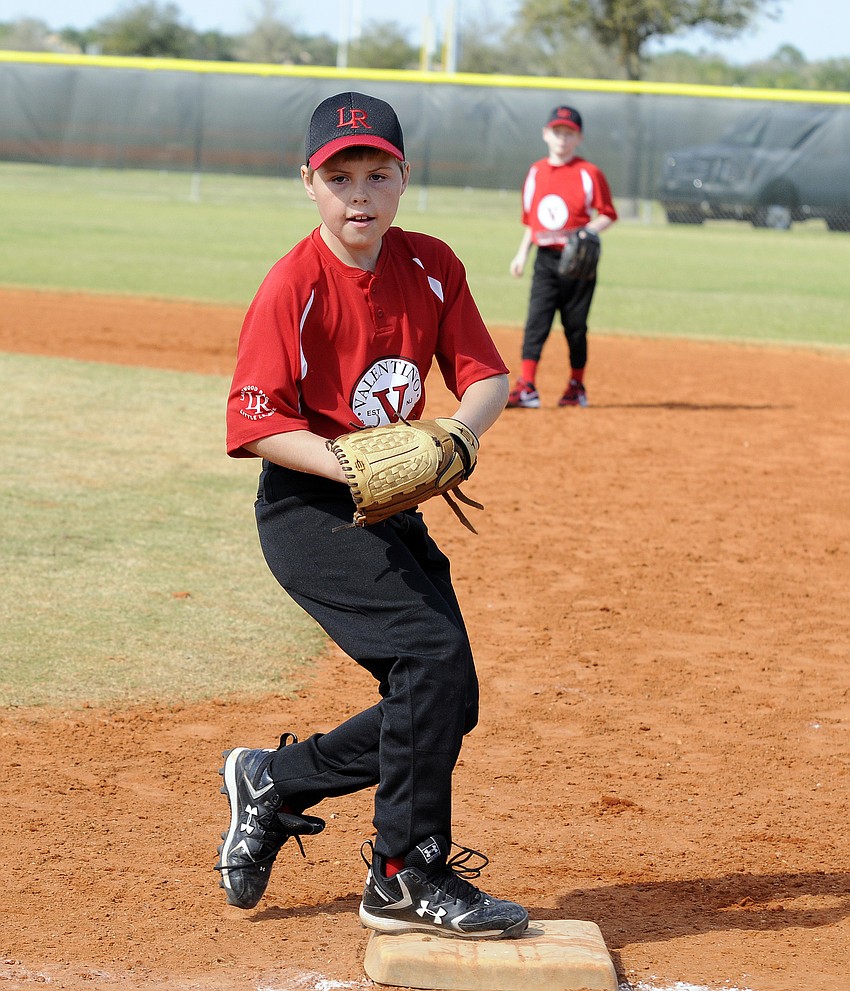 First baseman Logan Lipker tags the bag for the final out of the inning.
