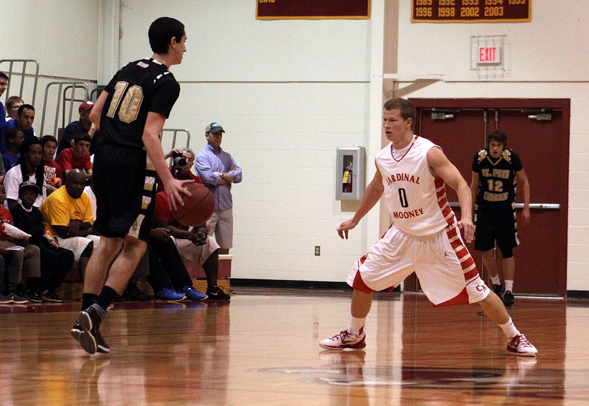 St. Petersburg Catholicâ€™s Mike Fridella, No. 10, tries to dribble past Cardinal Mooneyâ€™s Jamie Glasser, No. 0.