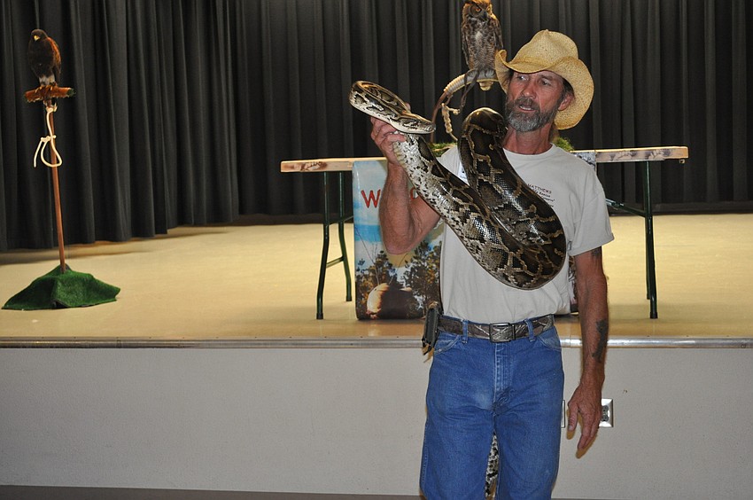 Matthews held a 14-foot Burmese python.