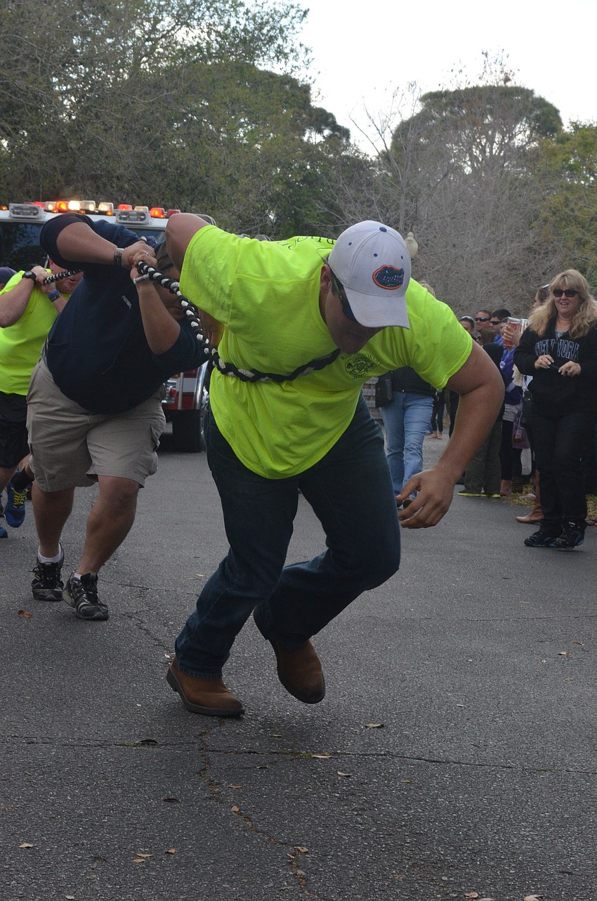 Zack Ballard, of the Nokomis Fire Department, takes the lead in the Pumper Pull. The six-man team finished with a time of 36 seconds.