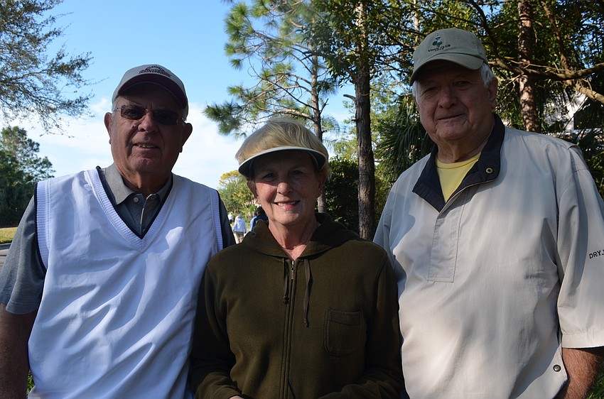 Ron and Kathy Haesele walk with Bob Flory.