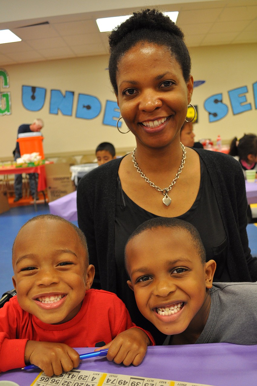 Dakarai Pitts, right, gave a thumbs down when asked how his bingo game was going. He still enjoyed the night, however, with his brother, Jahari, 4, and mom, Tonya.