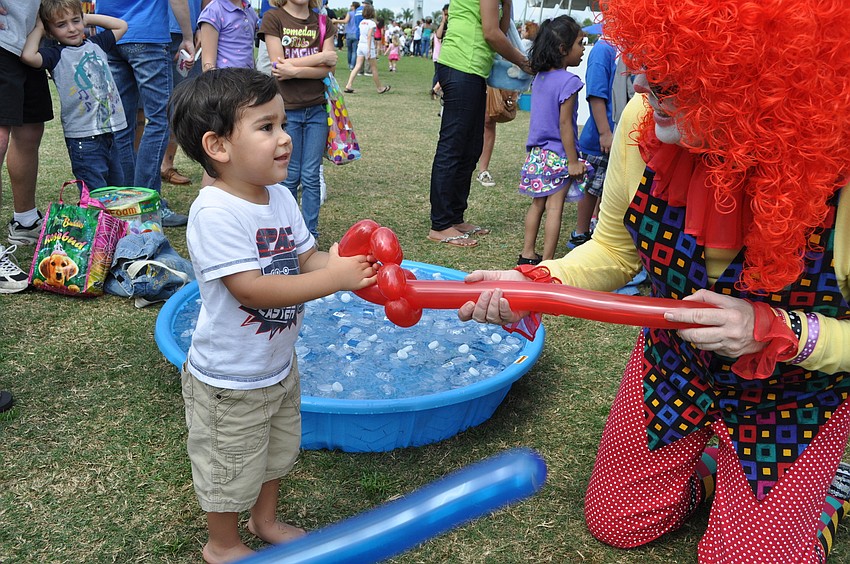 Wesley Beecher tugged at a balloon made by a clown.