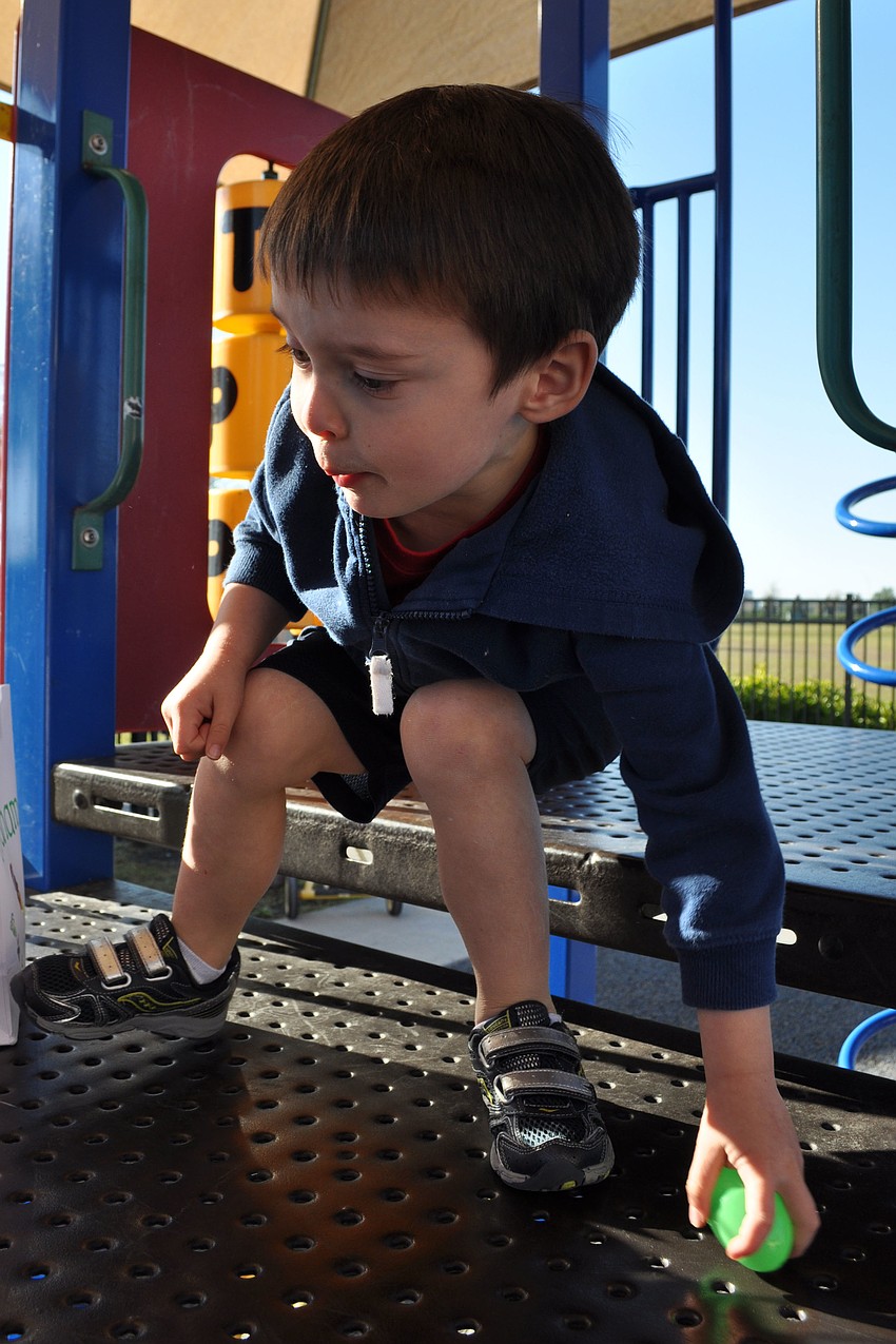 Graham Schlick, 4, searched high and low for eggs on the playground.
