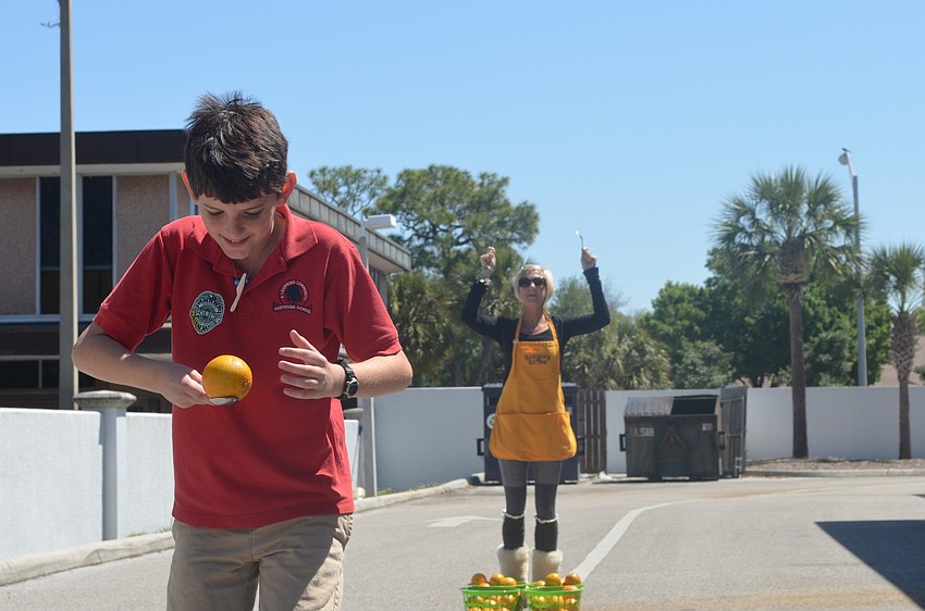 Fifth grader Mason Thomas runs a relay orange race with classmates at the Brownâ€™s Grove zone. Ally Jaynes was one of seventy-five volunteers at the event.