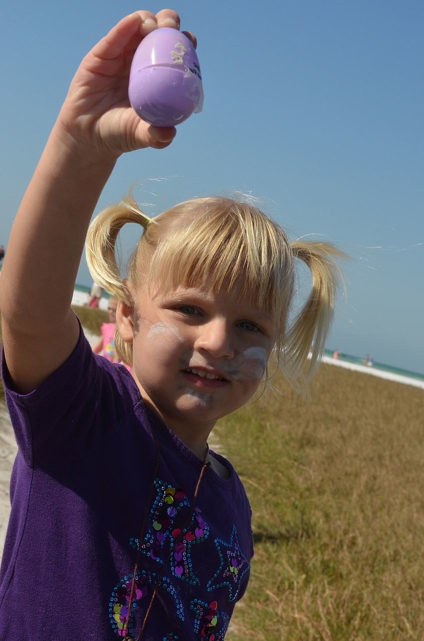 Kendall Alt shows off the egg she found. The eggs were wrapped with sponsorâ€™s names.