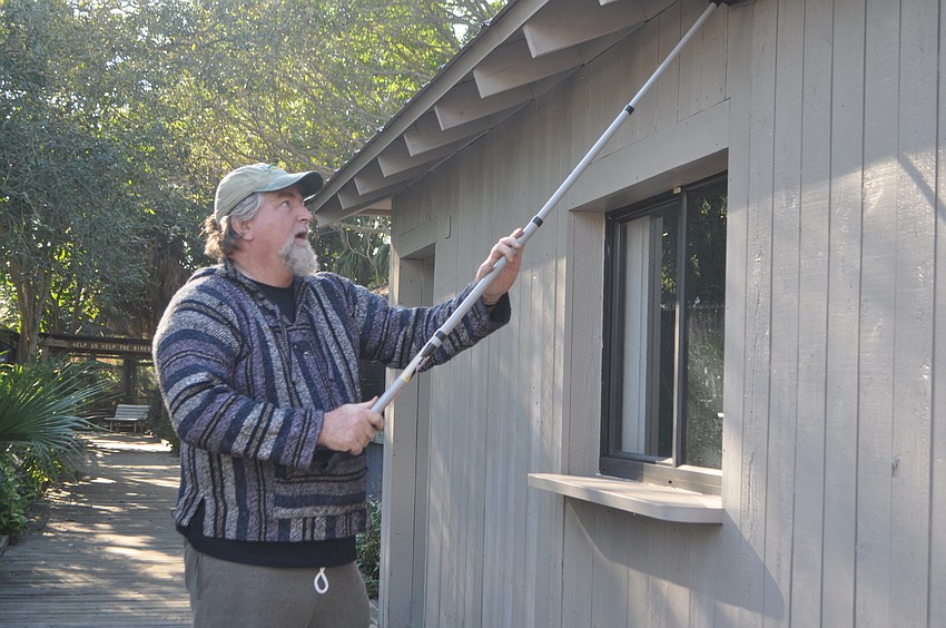 Rob McNeal preps the building for painting.