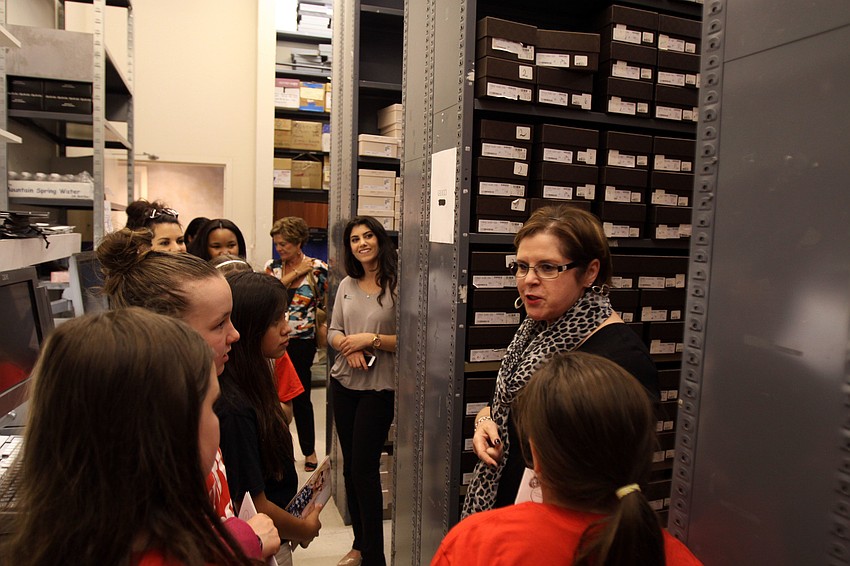 Susan Brothers shows the girls the shoe stock room.