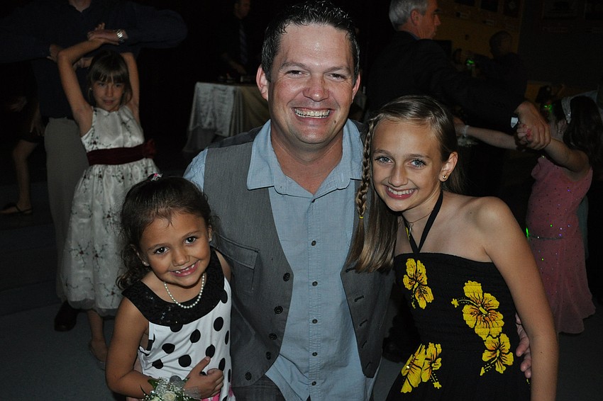 Duane Curry danced the night away with his daughters, Samantha, left, and Ciara, right.