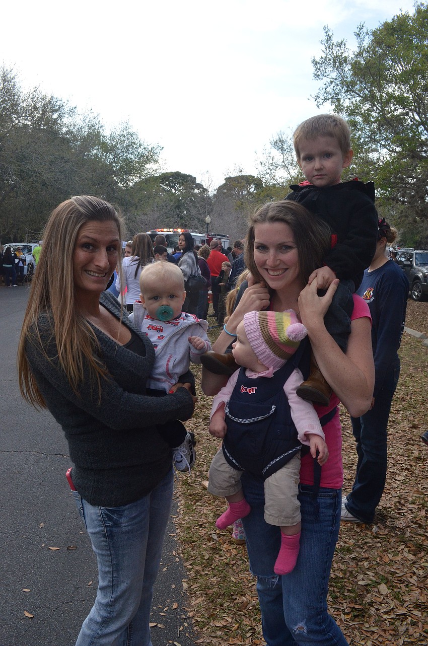 Desirae Young Nilson holds her son, 6-month-old Kaidan, while Samantha McDonough holds her children, 7-month-old Lilyanna and 3-year-old Tyler.