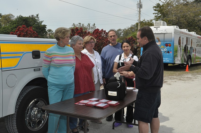 Lt. Rocky Parker, far right, demonstrates how a cardiac monitor works to Betty Jo Haas, Penny Ellis, Connie Haas and Vic and Maria Levine.