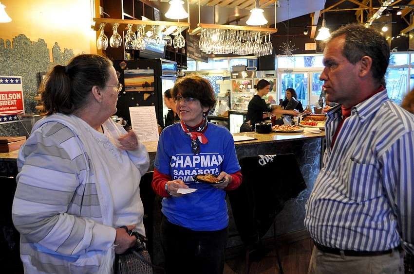 Susan Chapman talks to supporters at her watch party.