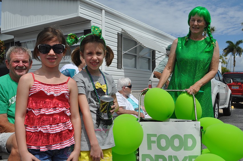 Kailey and Claire Weberding give Nancy Kryway a donation for All Faiths Food Bank.