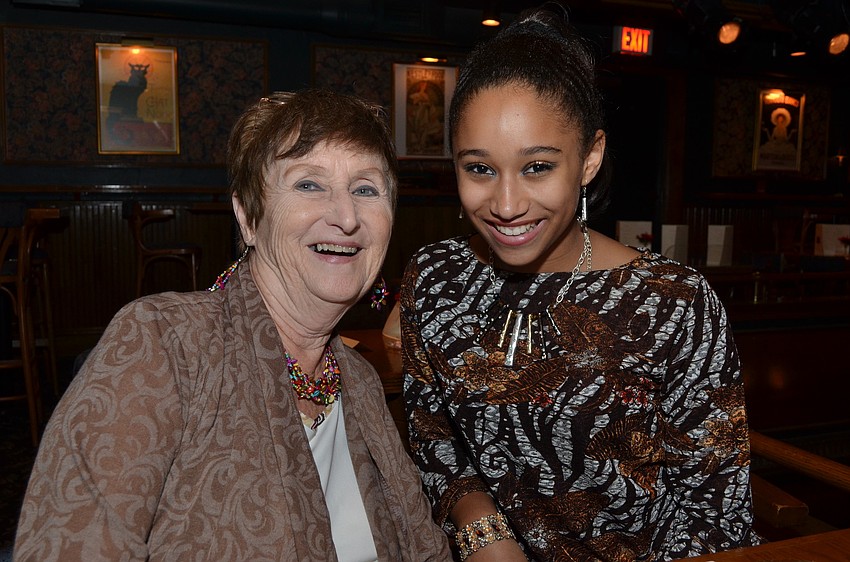 Maria Wirries waits for the program to begin with her mother Jeanne. Maria later sang for the crowd.