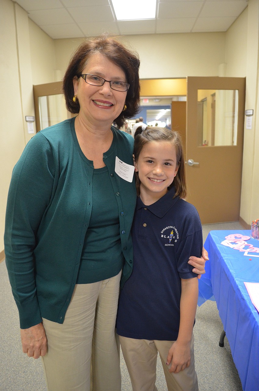Janet Pattison writes a story at one of the activity stations with her granddaughter Cassidy Pattison.