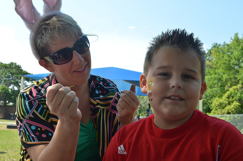 Lisa Singeisen paints Tanner Bullinerâ€™s face.