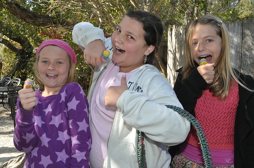 Emily Sackett, 10, Mary Grace Cucci, 10, and Gianna Sparks, 10, show off their candy rings.