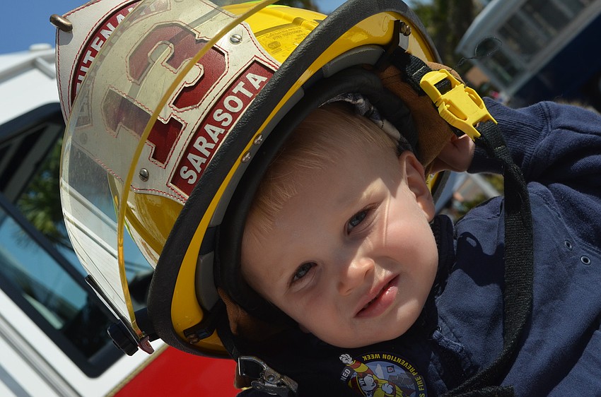 Kieran Kline â€“ Shore loves playing with hats according to his mom. He tries on a fire helmet.