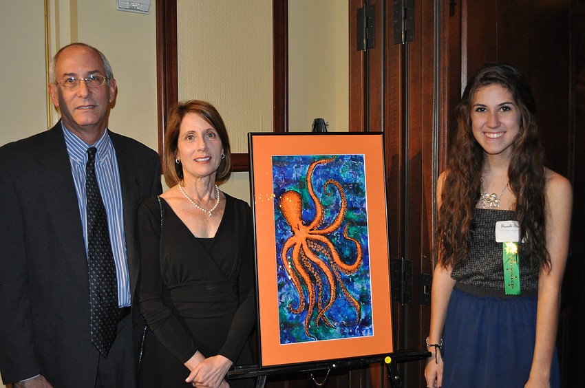 Sarah Smith, a Manatee High School junior, with her Octopus made out of pen, ink, acrylics and watercolor. Sharon and Jerry Schoenholtz looked on.