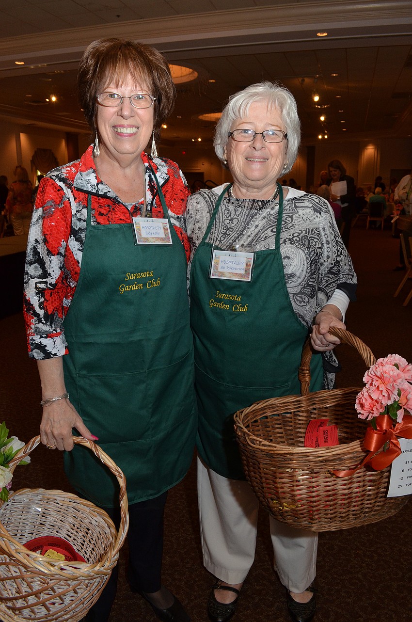 Judy Keller and Jan Johannesen sell raffle tickets at the luncheon.