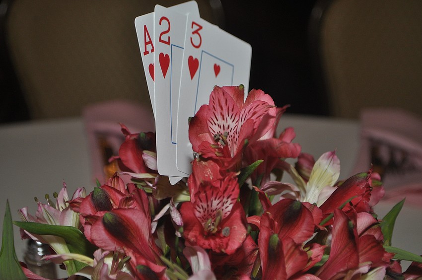 Centerpieces included alstroemeria and playing cards.