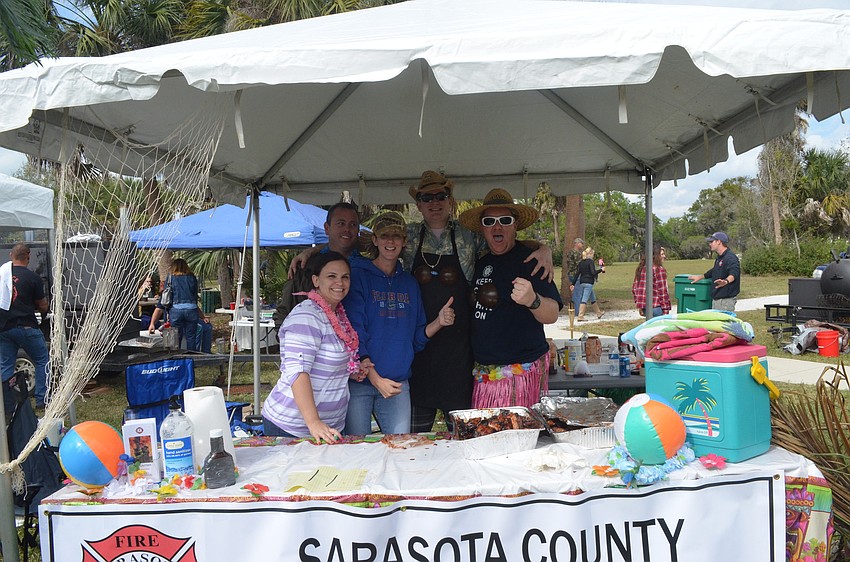 Volunteer Sarasota County Fire Fighters Alicia Puzzanchera, Joe Raridan, Jennifer Halbert, Matt Wilson and Aaron Atkinson marinated their ribs the night before and used four ovens to cook all of them.