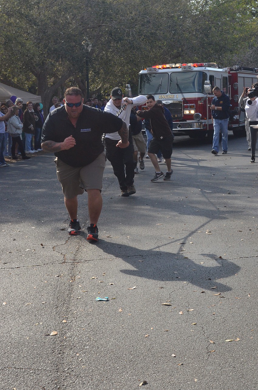 Sean McCutcheons takes the lead of the Fire Administration team that finished with a time of 39 seconds in the Pumper Pull.