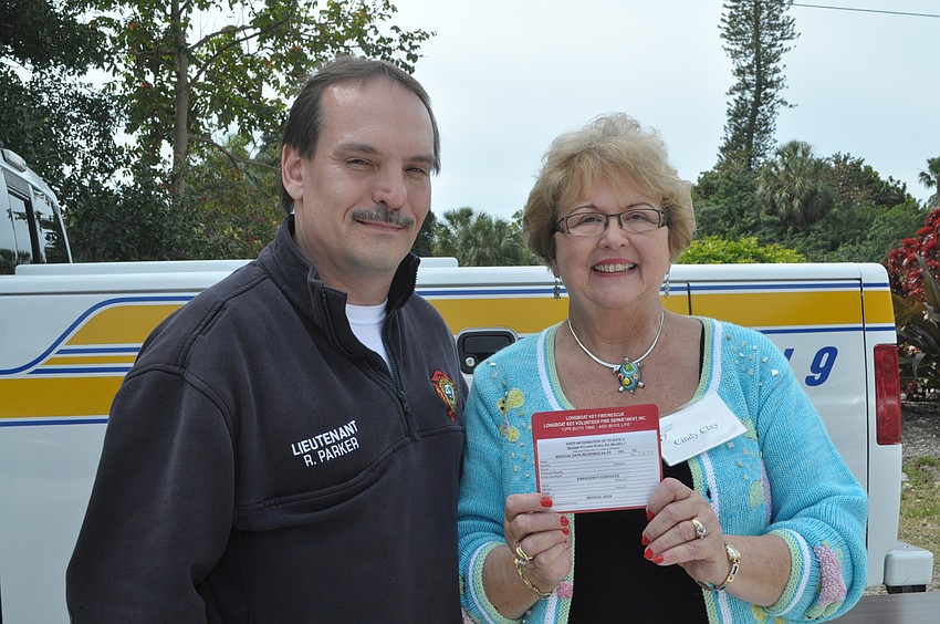 Lt. Rocky Parker and Cindy Clay hand out â€œfiles of life,â€ magnetized cards that contain personal and medical information to assist firefighter paramedics working under pressure.