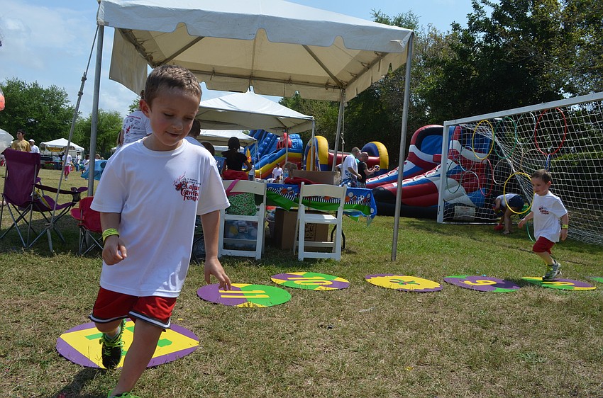 Brothers Andrew and Matty Bell go around the cake walk in hopes of winning a cake from Publix or from Cakes by Ron.