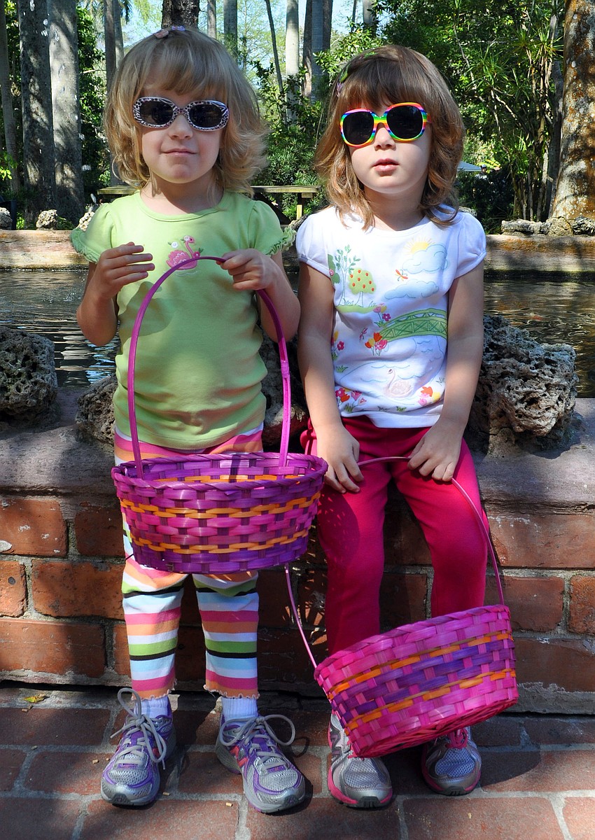 Angela and Kimberly LaVick, 3, wearing their fun sunglasses and carrying their Easter baskets.