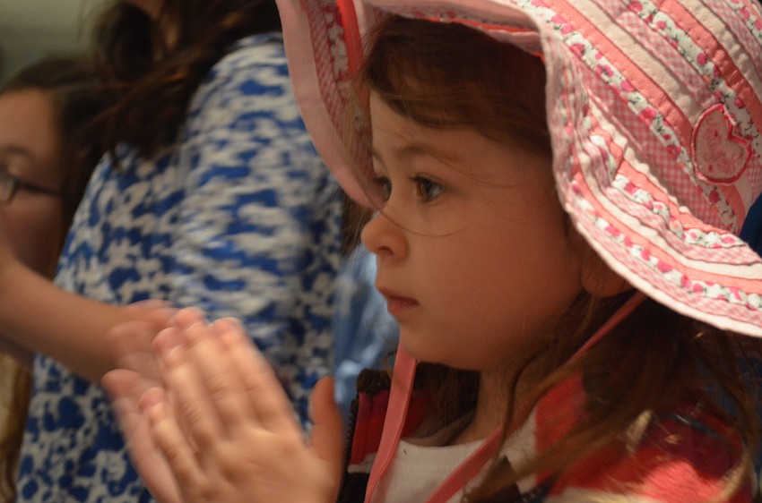 Emma Rudisell applauds Granny Goose during story time.