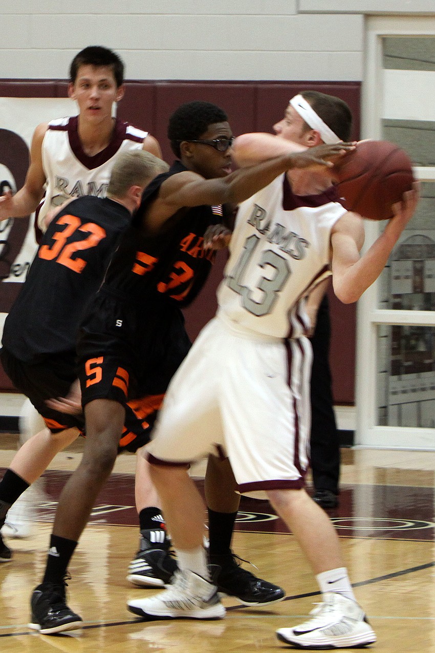 Sarasotaâ€™s Shaquese Johnson, No. 31, does his best to stop Riverviewâ€™s James Robustelli, No. 13, from passing the ball.