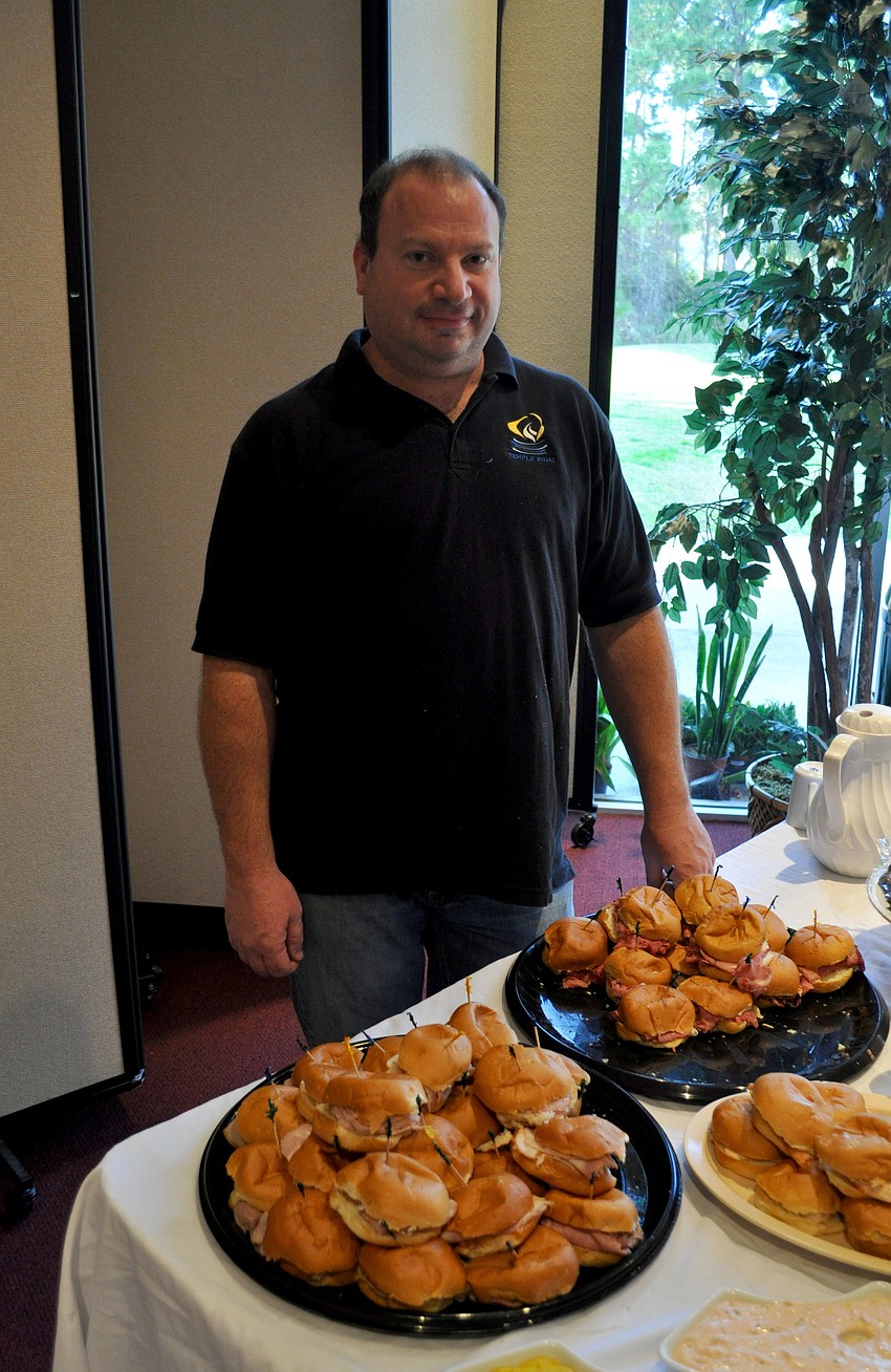 Michael Lauberblat, one of the chefs, stands near the food table.