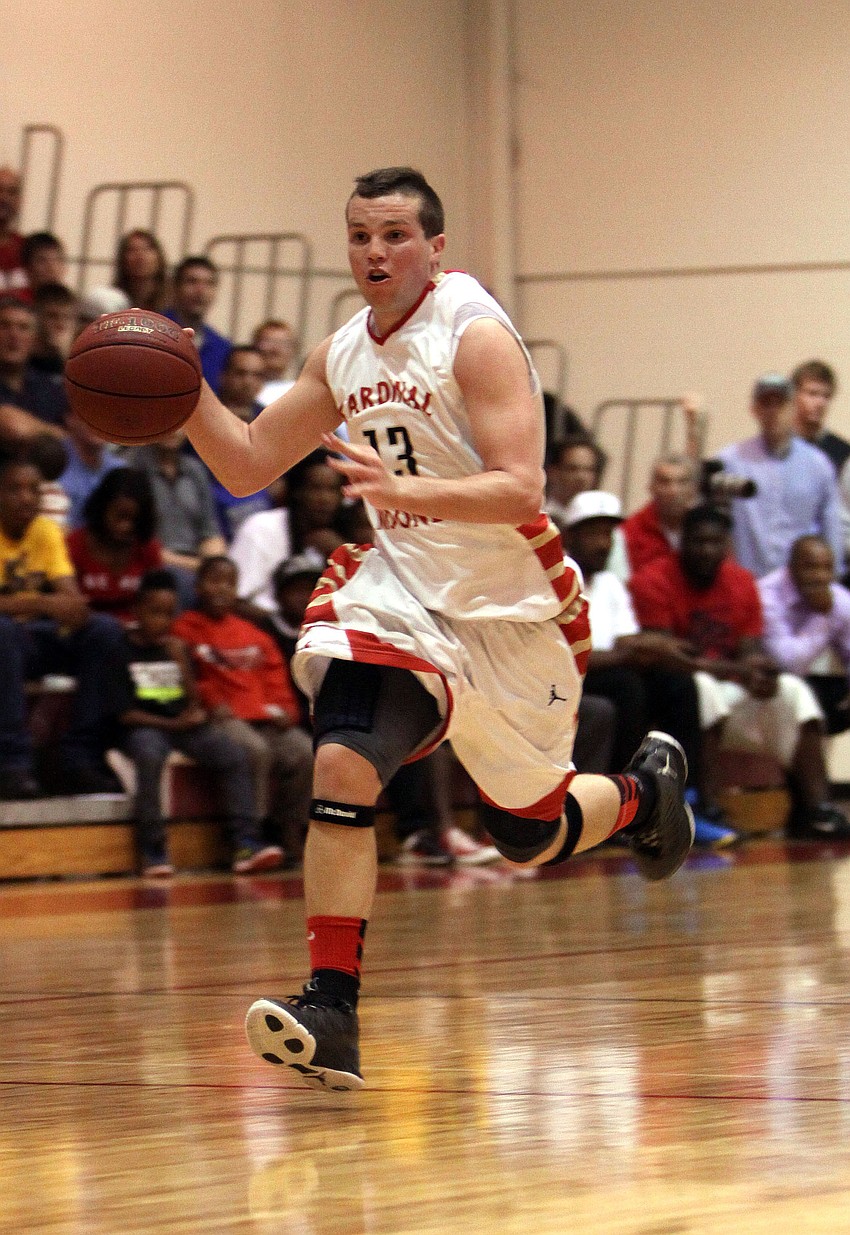 Cardinal Mooneyâ€™s Parker Del Medico, No. 13, dribbles the ball down the court.