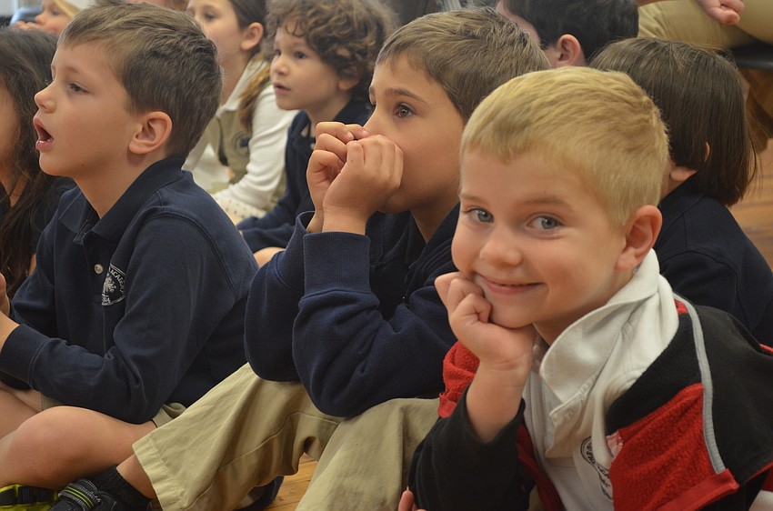 Children listen to seniors read a Dr. Seuss book.