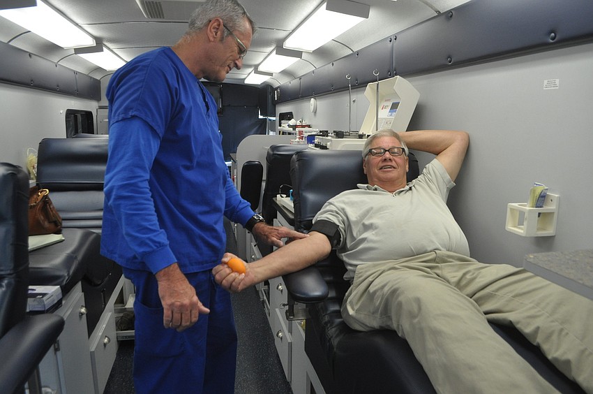 Fran Fougere preps John Holtzermann before a blood donation.