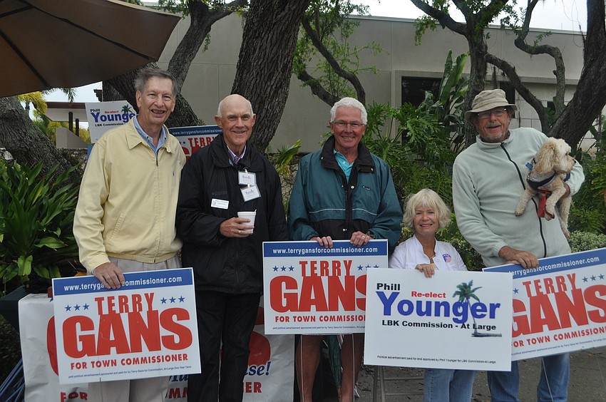 Jim Hensal, Commissioner Phill Younger, Milan and Linda Adrian, and Larry Straff with his dog, Racquet, show support for Younger and Commissioner Terry Gans.