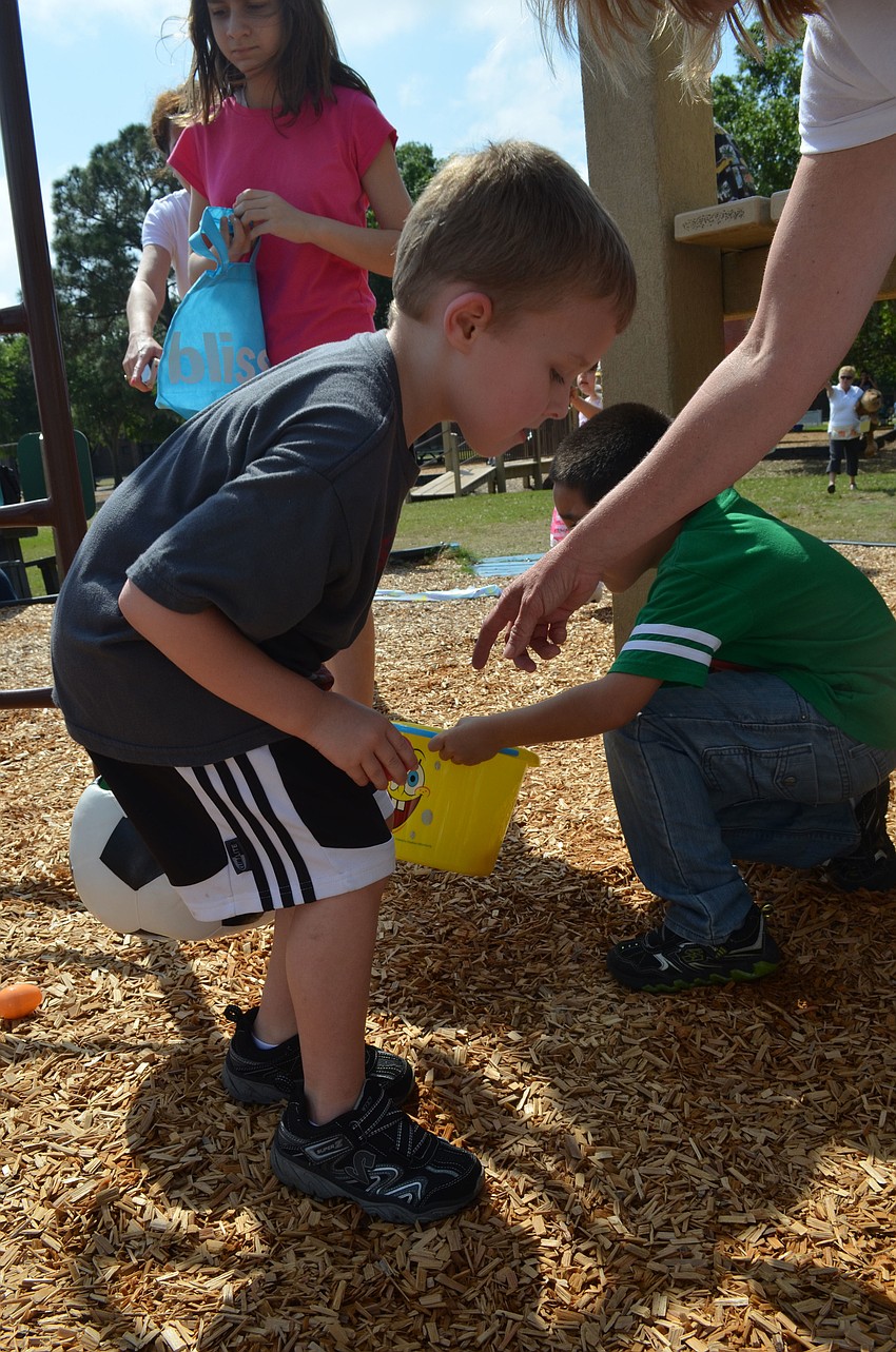 Travis Neidert searches the playground for eggs.