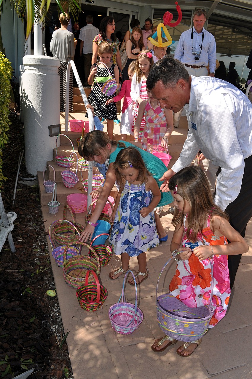 Children pick out their Easter baskets before hunting for eggs at Bird Key Yacht Club.