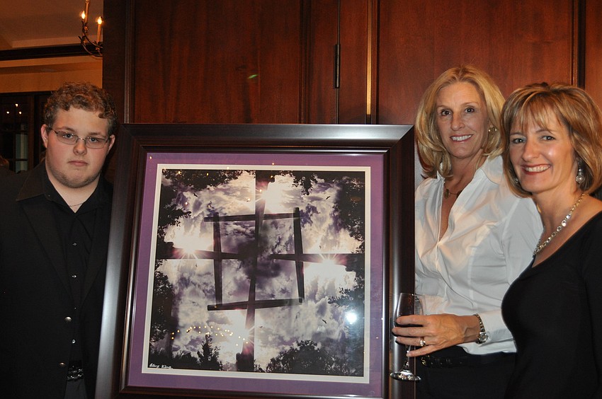 Alexander King, a Manatee High School sophomore, took a photo of the cross at Desoto Park using his phone. Maureen Platt and Kim Daunt enjoyed it.